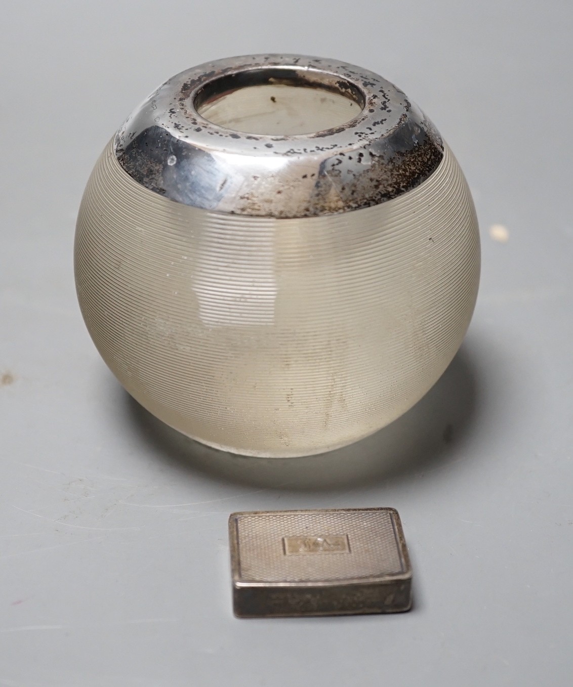 A George V silver mounted ribbed glass match strike, height 75mm and a late Victorian silver pill box.